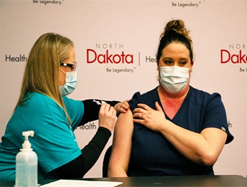 A nursing home staff member gets vaccinated in Mandan, North Dakota.