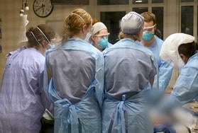 Doctors and nurses operating on a patient