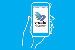 Hand holding smartphone showing v-safe app
