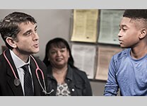 Doctor talking to boy and his mother