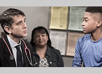 Doctor talking to boy and his mother