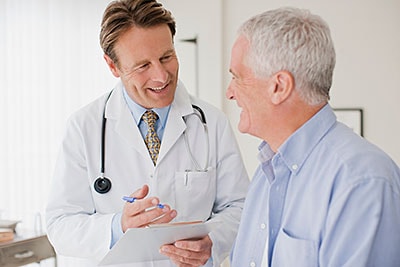 Male doctor talking with male patient