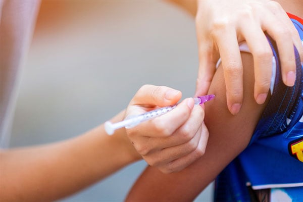 Vaccine shot applied to patient's arm