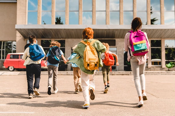 A group of young children walking into school