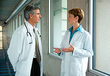 Male doctor talking with a female doctor