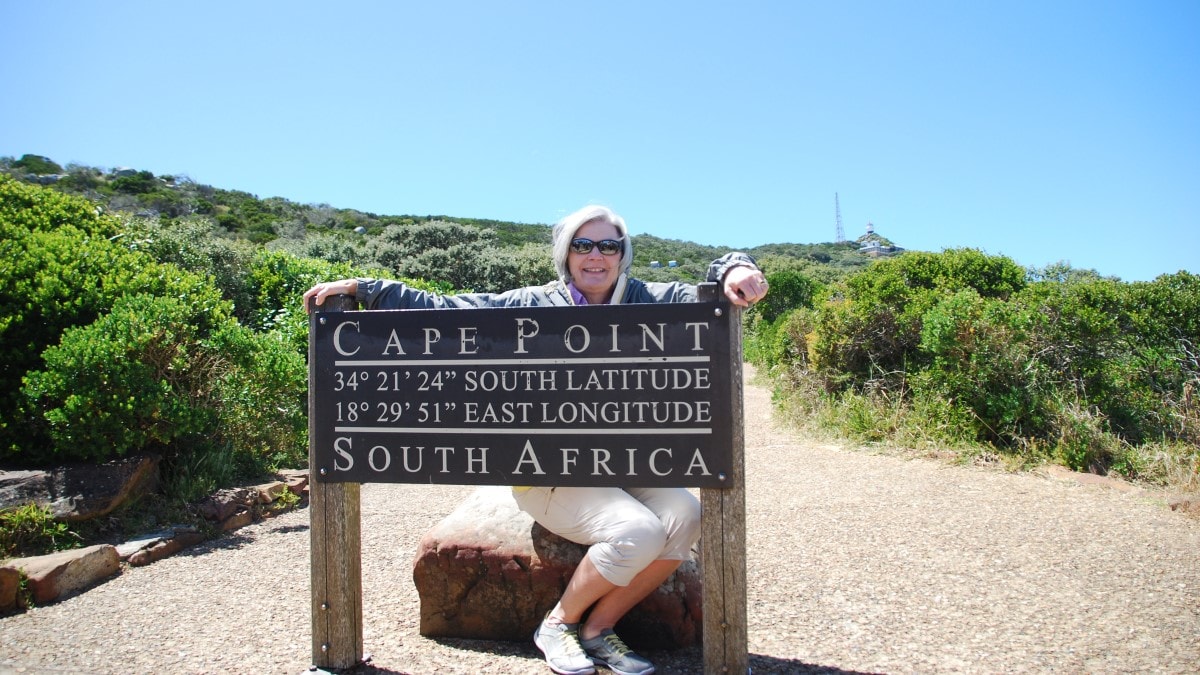 woman with a sign in Cape Point, South Africa