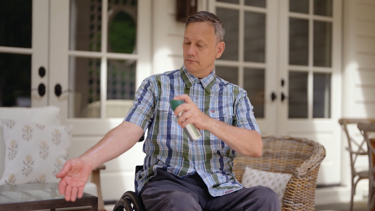 Man applying insect repellent to prevent mosquito bites.