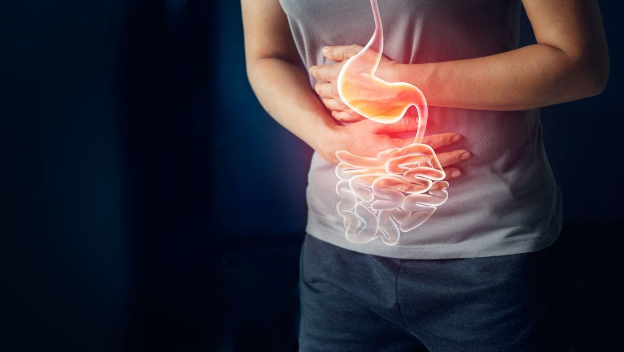 Photo of person clutching their stomach from gastrointestinal illness.