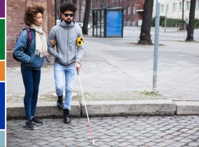 woman holding boyfriend's arm who is blind