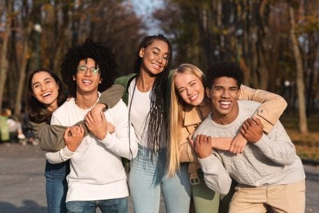 positive group of teens hanging out