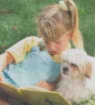 A picture of a girl and her dog, but the image is cloudy and the colors less vibrant.