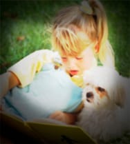 A picture of a girl and her dog, but the image is blurry and the outer corners are dark.