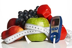 Fruit, measuring tape, dumbbell, glucose monitoring meter