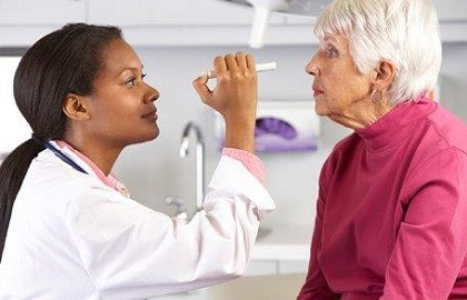Doctor giving eye exam to patient