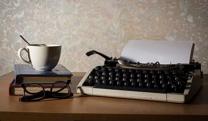 A cup of coffee and old fashioned typewriter