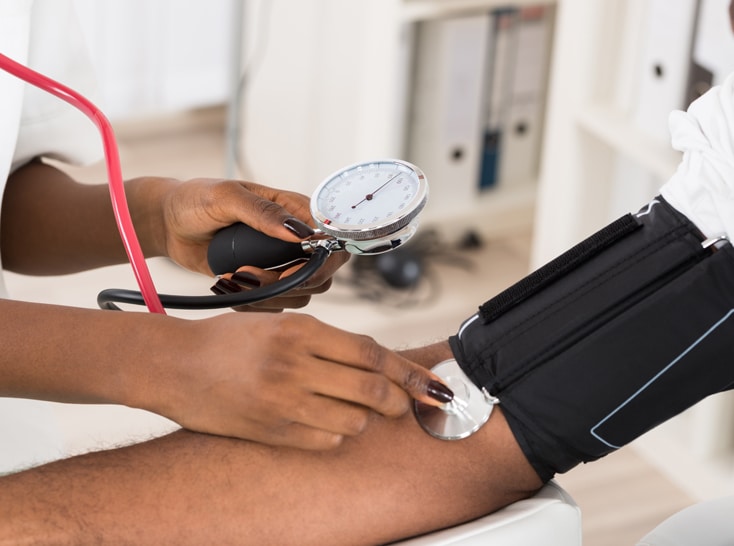 Healthcare worker taking patients' blood pressure