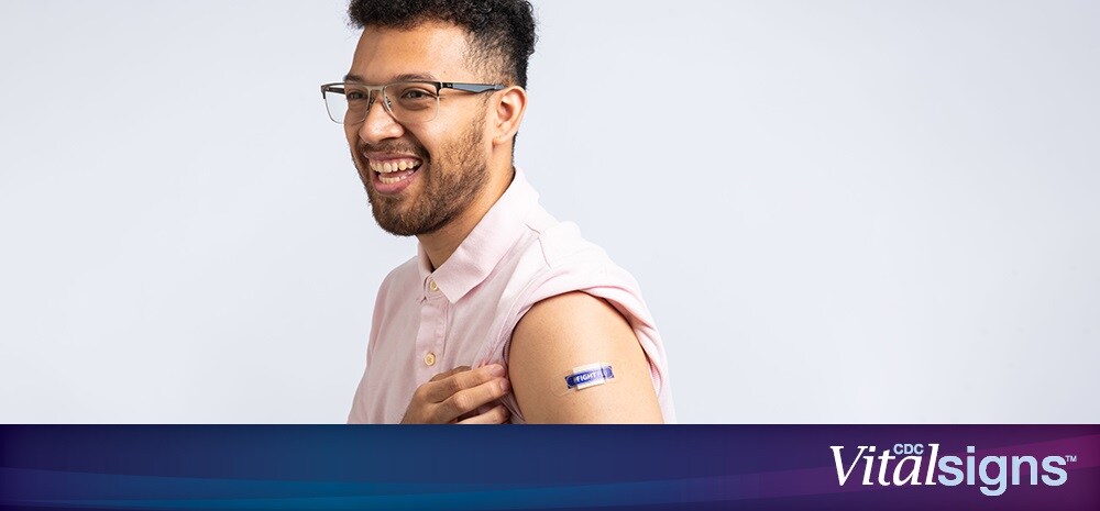 A photo of a man proudly displaying a bandage from a flu vaccination