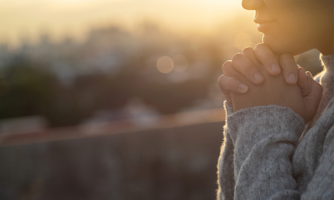 A person with hands clasped