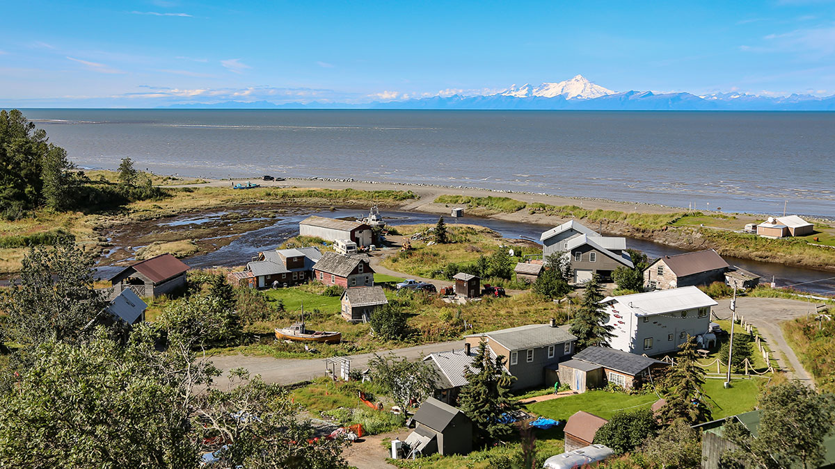 Aerial view of a remote Alaska community beside a river.