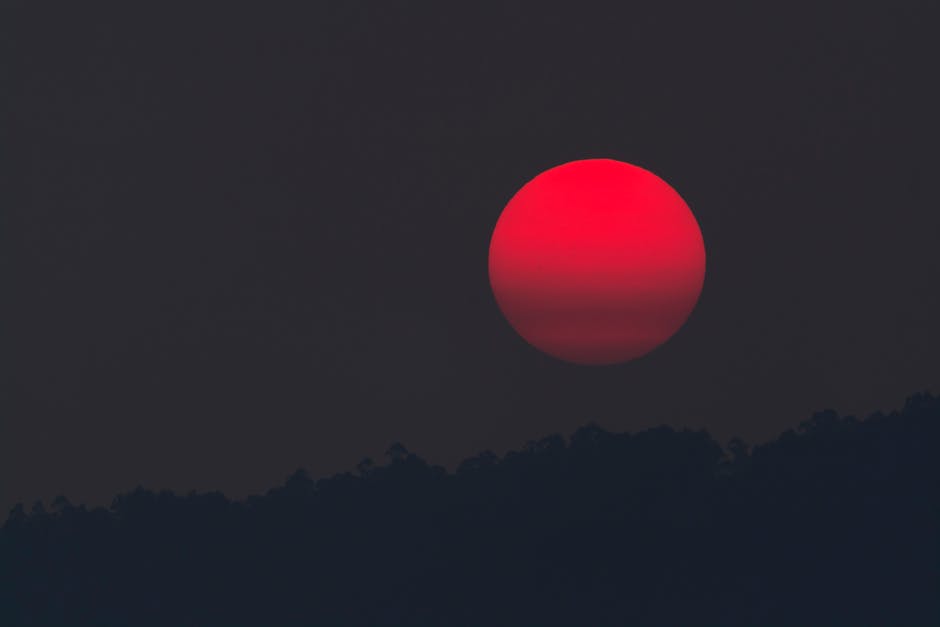 glowing red moon on a dark night