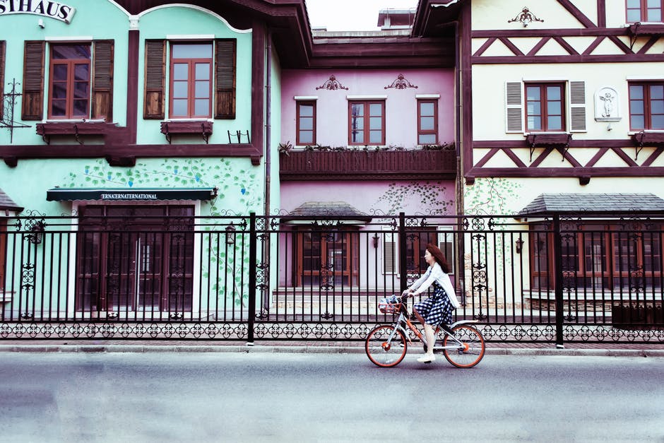 Example image: woman bicycling through village