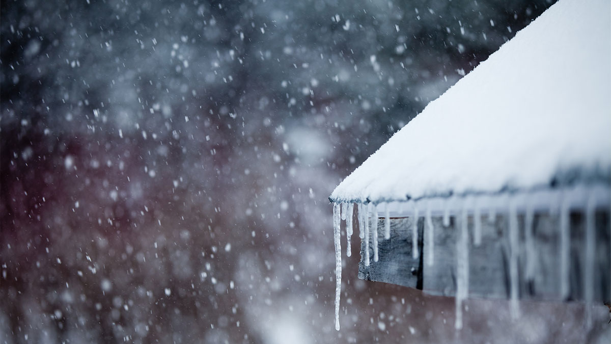 Icicles forming on snow covered roof