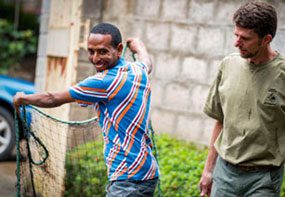 An Ethiopian animal rabies surveillance officer practices throwing a net to safely capture street dogs for vaccination.