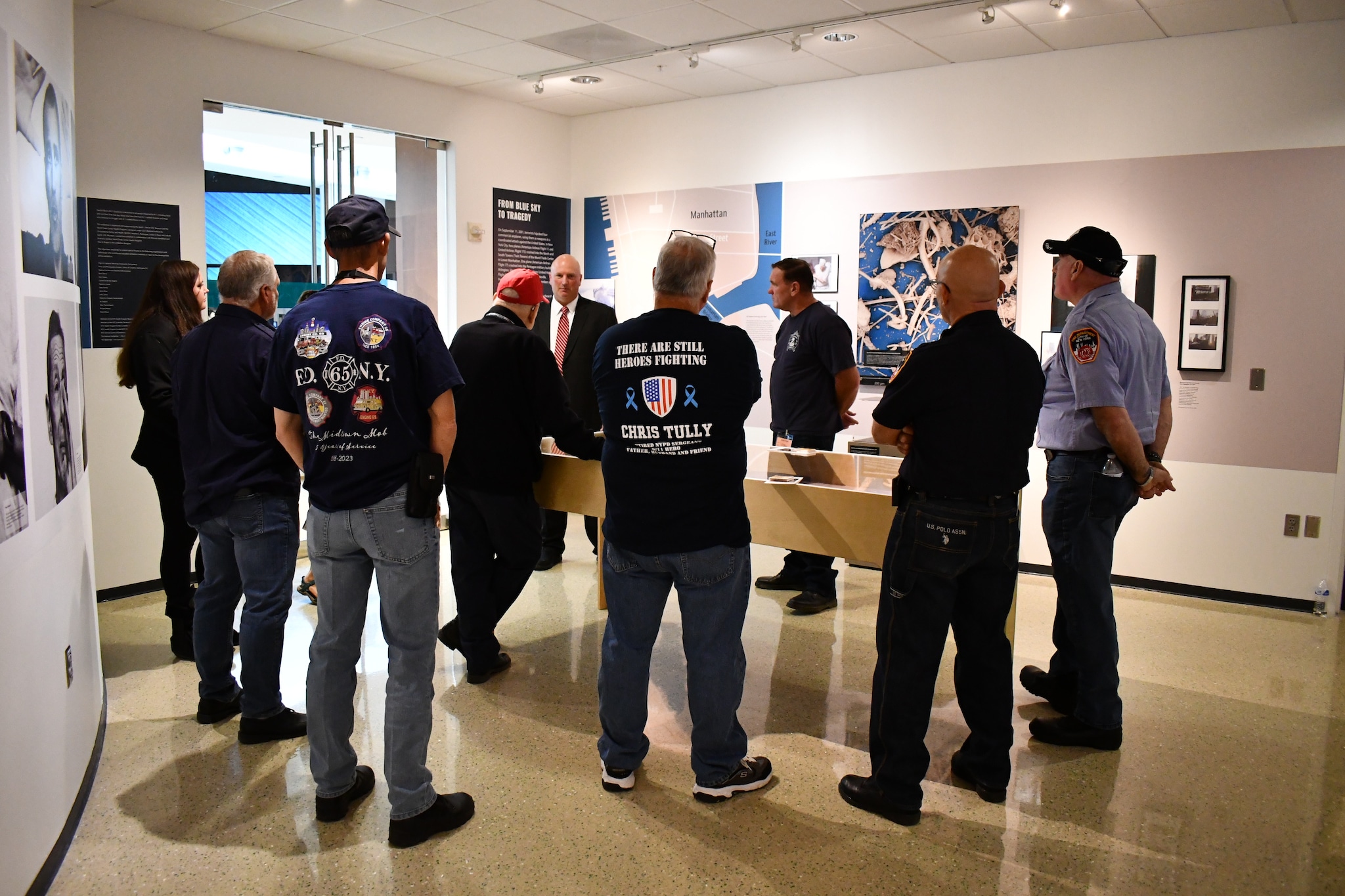 Tim Murphy and a group of fellow responders viewing the Health Effects of 9/11 Exhibition.