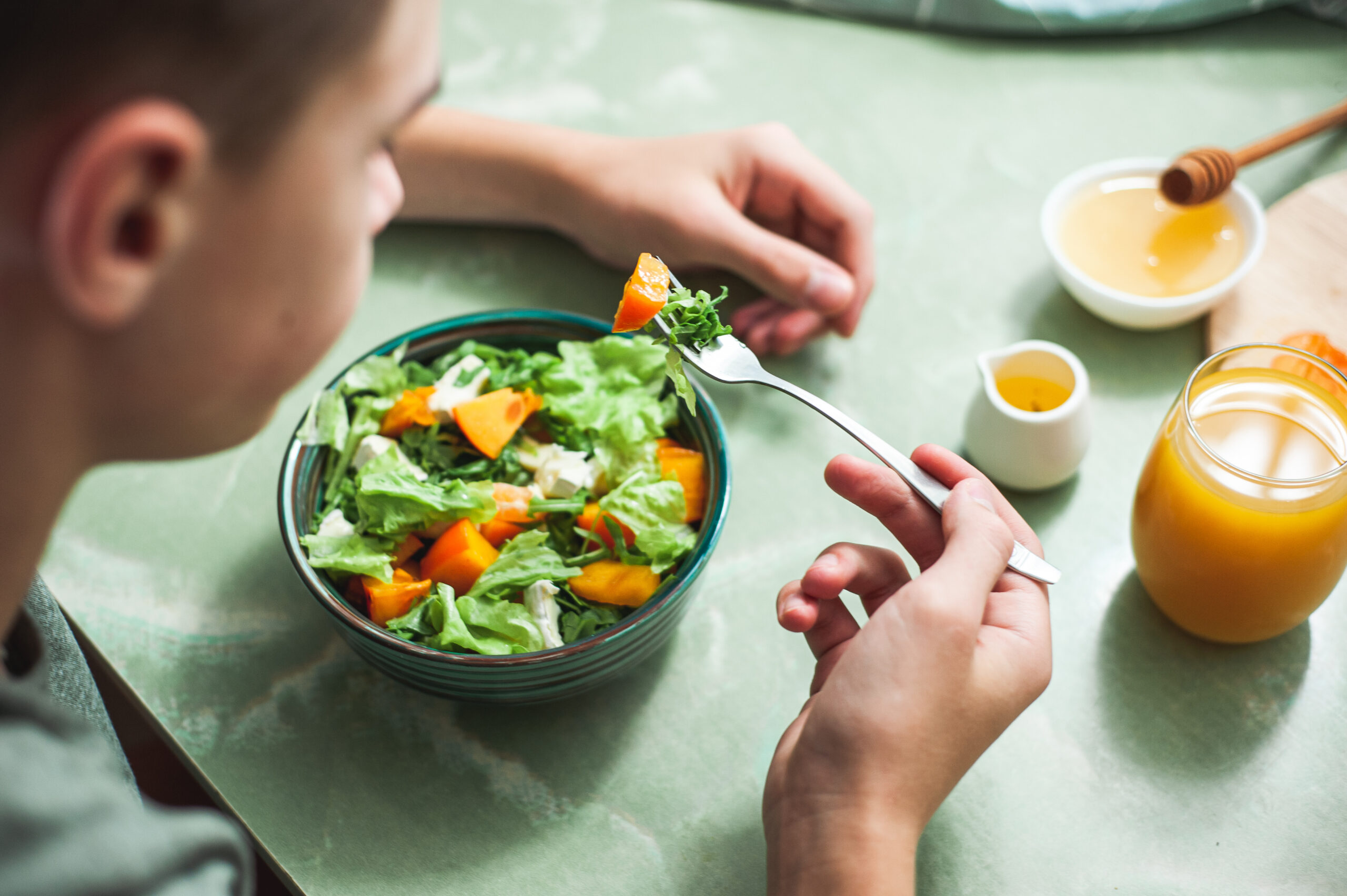 High school student eating a salad.