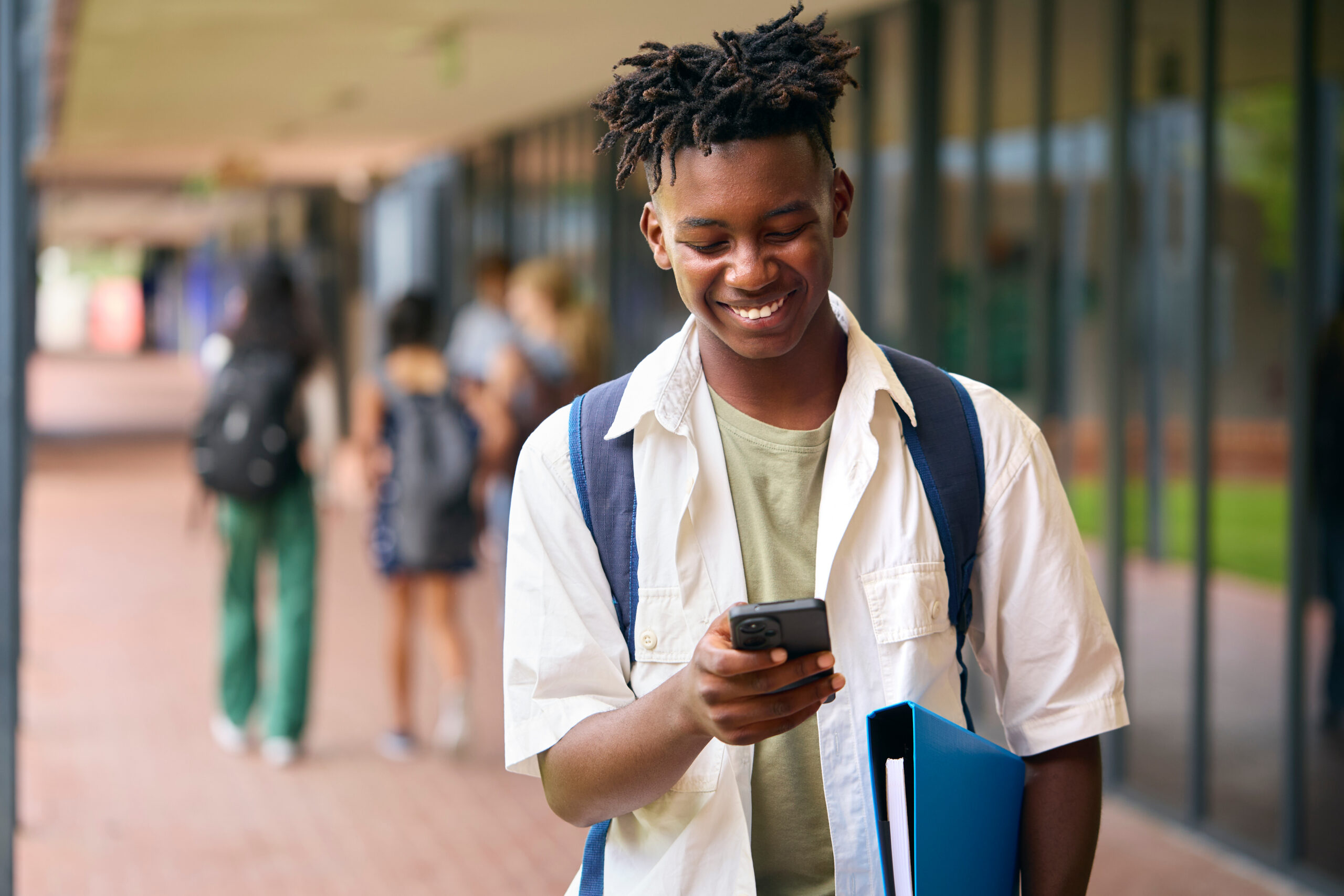 A high school student on his cellphone.