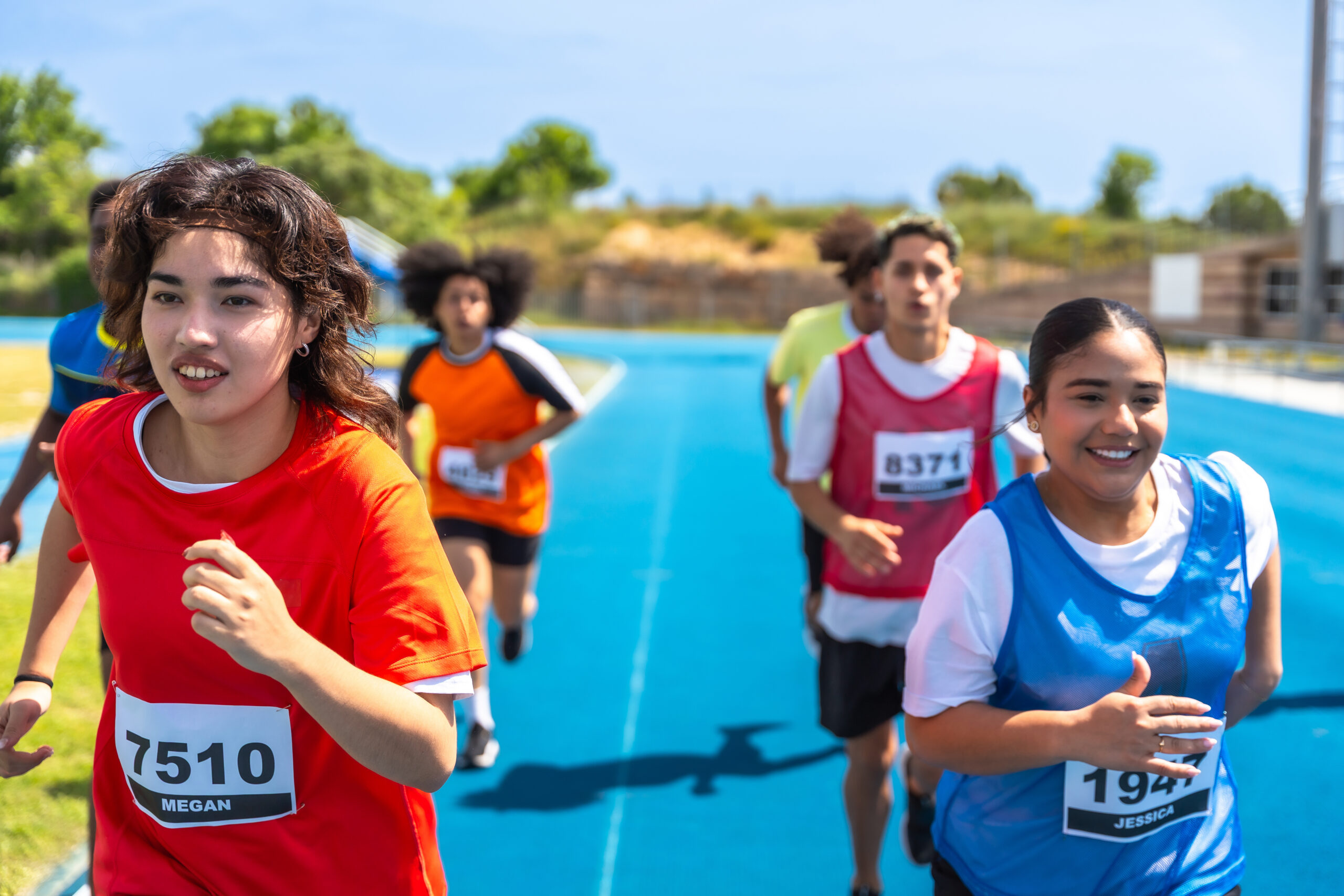 High school students running in a track event.