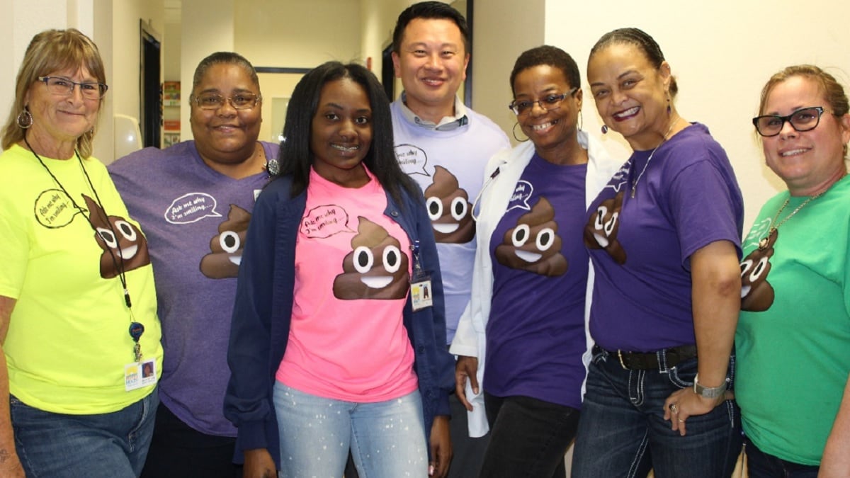 Photo of staff at the St. Petersburg medical home wearing humorous T-shirts to promote colorectal cancer screening with a FIT kit.
