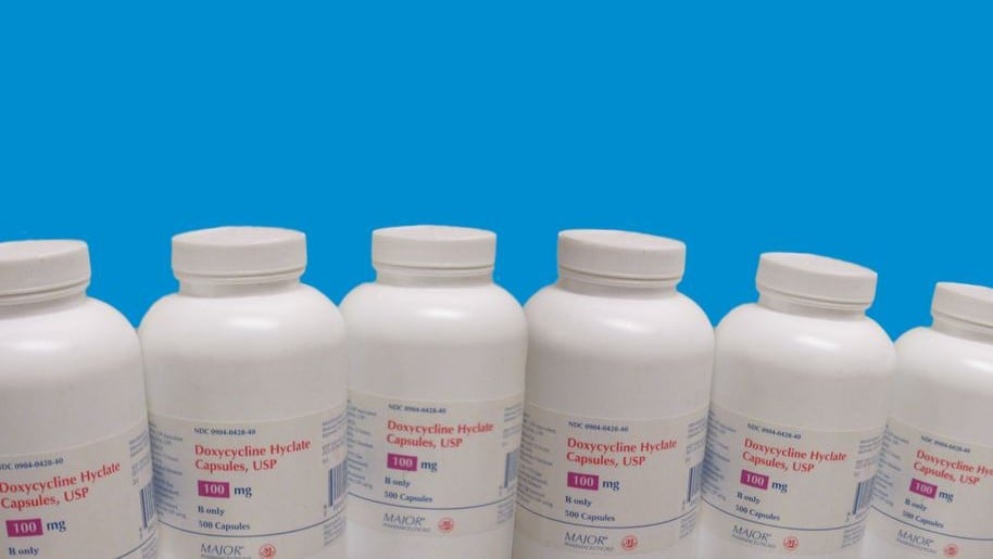Several doxycycline bottles lined up in a row