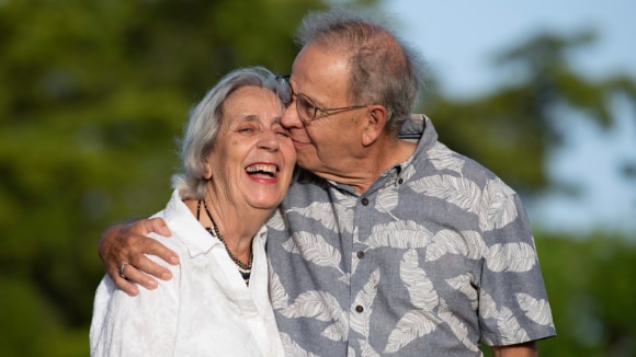 elderly man and woman embracing