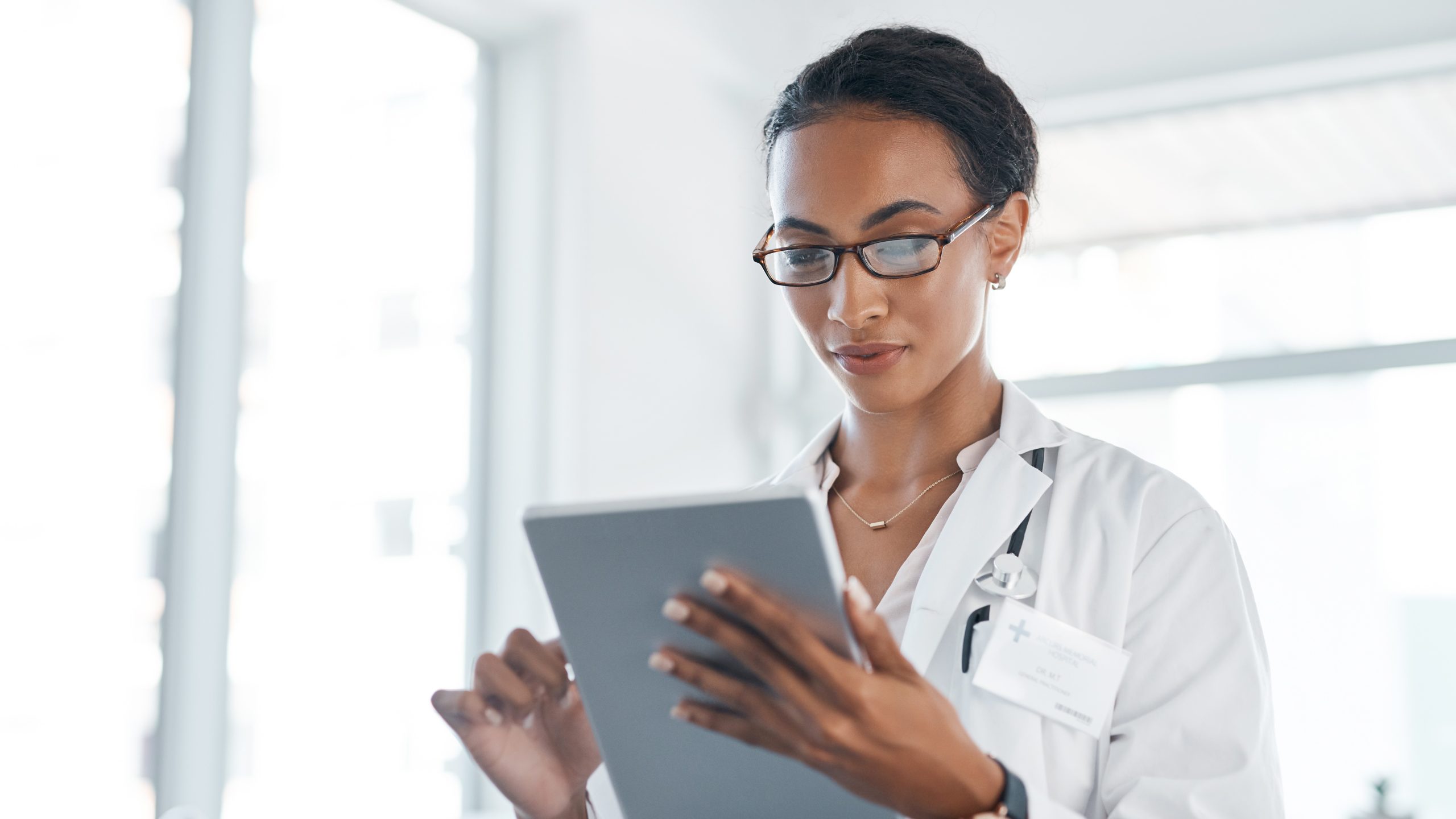 Female doctor looking at a tablet computer.